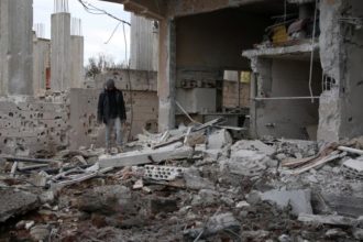 A man inspects a damaged house after an airstrike on al-Yadouda village, in Deraa Governorate, Syria February 15, 2017. REUTERS/Alaa Al-Faqir